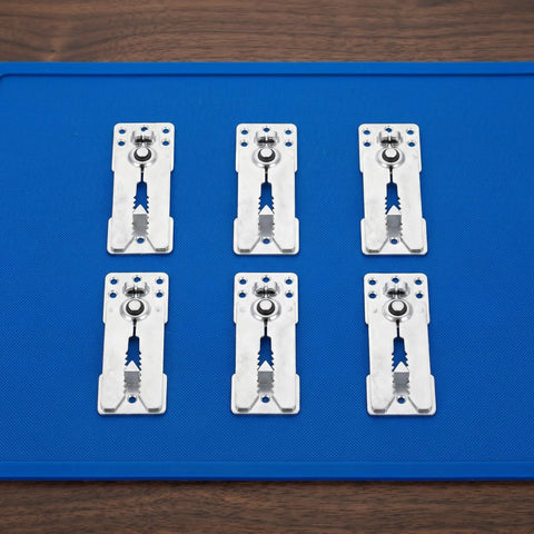 Six Piece Heavy Duty Stainless Steel Sectional Couch Connectors Featuring Grippy Double Tooth Brackets To Lock Down Modular Sofas And Keep Your Setup Solid, arranged on a blue mat.