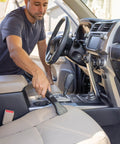 Pro-Grade 1-1/4 In Wet Dry Shop Vac Attachment Kit With Reinforced 11 Ft Hose in use, cleaning car upholstery and console.