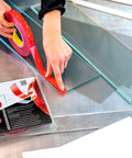 Person using VHB 4910F Clear Double Sided Acrylic Foam Tape for Transparent Bonding, 19 mm x 11 m, on glass, adhesive roll