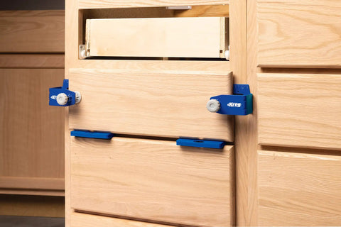 No Hassle Magnetic Setup And Spacer Shims For Pinpoint Drawer Alignment Durable Plastic Carpenter Blocks being used on wooden drawers.