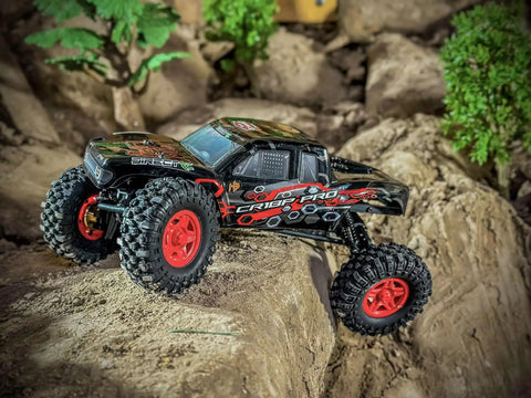 1/18 RC Crawler Pro Juice Up Edition RTR With HBW Electronics, 2.4GHz 4CH Radio, Brushless Power, red wheels on rocky terrain