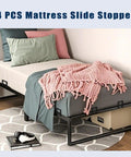 Heavy Duty Adjustable Anti Slip Mattress Grippers For Bed Frame on a bed with a pink blanket and pillows, showcasing retention features.