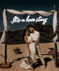 Couple under 'It's A Love Story Personalized Neon Light Sign For Bedroom And Wedding Decor Large 23.6 Inch LED Neon Sign'