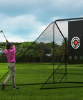 10x10 Golf Hitting Net With Side Barriers And Ball Return System For Indoor Practice shown outdoors with a golfer swinging