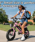 Teen riding 16-Inch Fat Tire Electric Mountain Bike with 800W Peak Motor, Removable Battery, Black Pink, on a sunny day