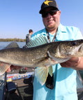 Angler holding a walleye caught using Rock Runner Slip Bouncer Weight with Quick Change Sinker for Walleye Trolling in Sunrise Color Three Quarters Ounce