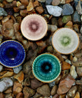 Marrakesh Mix Ceramic Cabinet Knobs Set Of 8 For Kitchen Cabinets And Furniture, four colorful knobs on stones