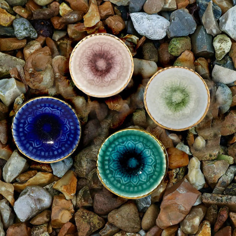 Marrakesh Mix Ceramic Cabinet Knobs Set Of 8 For Kitchen Cabinets And Furniture, four colorful knobs on stones