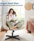 Woman sitting cross-legged on Wide Seat Comfy Office Vanity Chair With Swivel Armless Desk Stool in beige fabric, home setting.