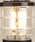 Close-up of the Northstar 1500 Lumen Gas Lantern with matchless lighting, showing bright light through its glass globe and wire guard.