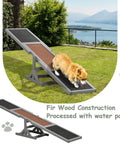 A dog on a 71 Inch Outdoor Dog Agility Seesaw for Training and Exercise made of slip-resistant fir wood in a backyard.
