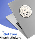 Laptop with a round cartoon-style sticker on the lid, featuring a smiling character with a text border, against a blue background.