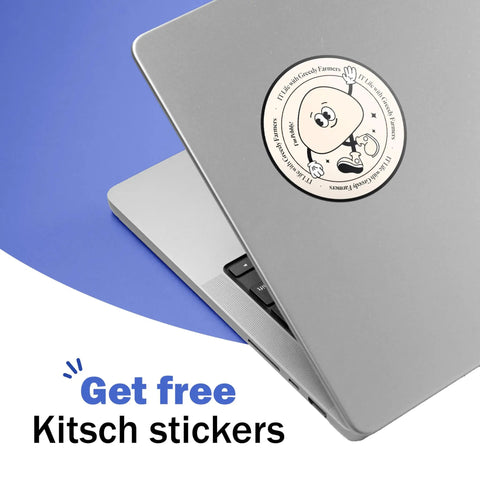 Laptop with a round cartoon-style sticker on the lid, featuring a smiling character with a text border, against a blue background.