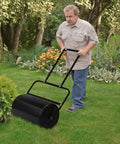 A man using Lawn Roller For Seed And Sod Preparation With 10 Gallon Water Fill Capacity And Welded Steel Drum Construction