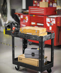 Top Tier Heavy Duty Two Shelf Utility Cart With Durable Structural Foam Lipped Trays And Smooth Glide Handles 500 Lb Capacity loaded with tools in garage.