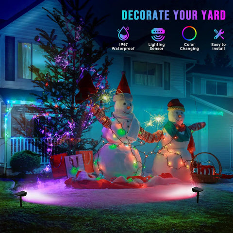 Solar Color Spotlight Lights Outdoor 35 LEDs Multicolor IP67 Waterproof 4 Pack illuminating snowmen in a yard at night