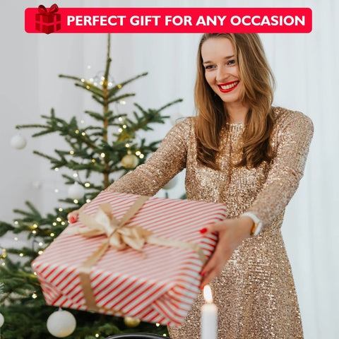 Woman in gold dress holding a wrapped gift in front of a Christmas tree with a sign reading 'Perfect Gift for Any Occasion.'