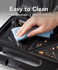 Hand cleaning the non-stick plates of the Ovente Electric Sandwich Maker With Quick Heating Non Stick Plates For Toasting Paninis And Omelets Perfect Hot Pressed Breakfast Grill Machine In Sleek Black Finish Fast Cooking Countertop Appliance.