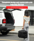 Woman holding tote bag near SUV with open trunk, showcasing durable and practical design.