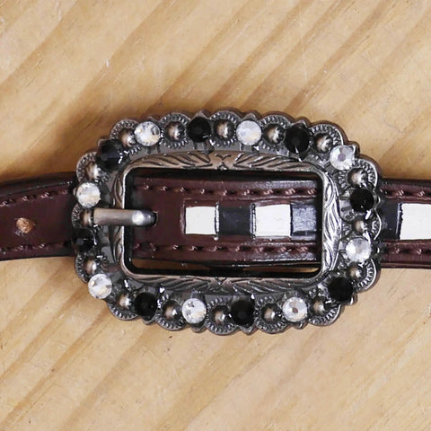 Top Shelf Western Leather Horse Tack Set Bringing The Boss Vibe To Every Ride With A Custom Headstall And Breast Collar Hand Carved With Vibrant Floral Patterns And Durable Antique Copper Hardware. Decorative buckle with silver and black accents on brown leather strap.