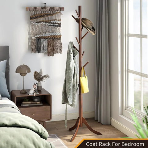 Freestanding Bamboo Coat Rack With 8 Hooks, Adjustable Height Entryway Stand in bedroom with classic brown finish.