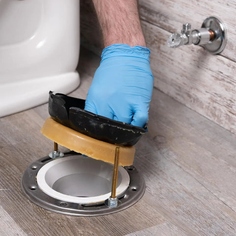 Heavy Duty Wax Bowl Ring For Toilet Installation Fits 3 Inch And 4 Inch Waste Lines, 100 Percent Petroleum Wax Gasket being installed