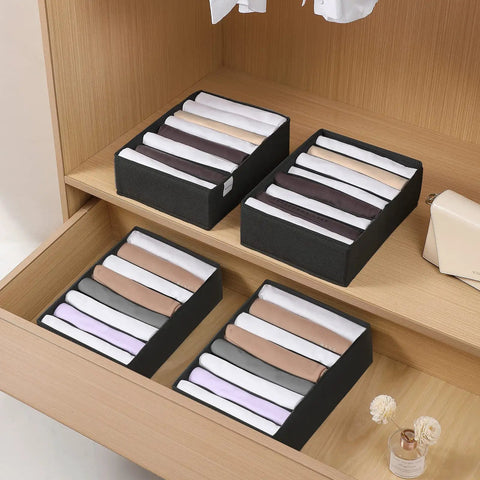4 Pack T Shirt Drawer Organizers With Eight Grid Compartments For Closet Storage Keeps It Tidy Built From Durable Nonwoven Fabric With Sturdy PP Board Sides Washable Organizer For Folded Clothes Leggings Silk Scarves Black neatly placed in a wooden drawer showcasing various compartments filled with folded clothes.