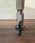 Size 8 By 0.75 Inch Black Phillips Modified Truss Head Wood Screw being driven into wood surface