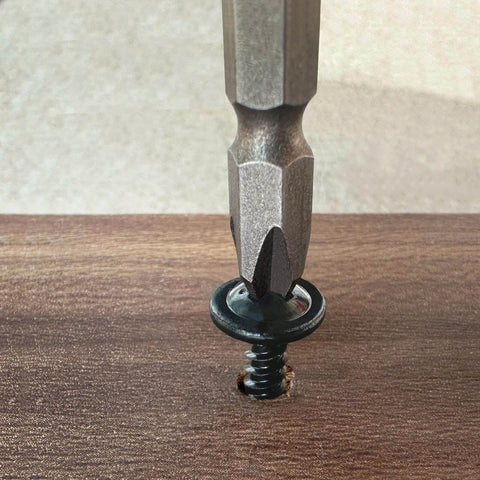 Size 8 By 0.75 Inch Black Phillips Modified Truss Head Wood Screw being driven into wood surface