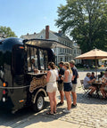Top Tier 10ft Slick Black Mobile Food Truck For Coffee Kiosks And Pop Up Catering With Reliable Walk Up Fridge Unit Factory Direct Certified Build Ready To Hustle Hard with customers ordering drinks.