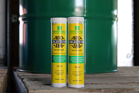 Two Bio High Temp NLGI 2 180 EP Grease 14 Oz Tubes in front of a green barrel, multipurpose wheel bearing lubricant