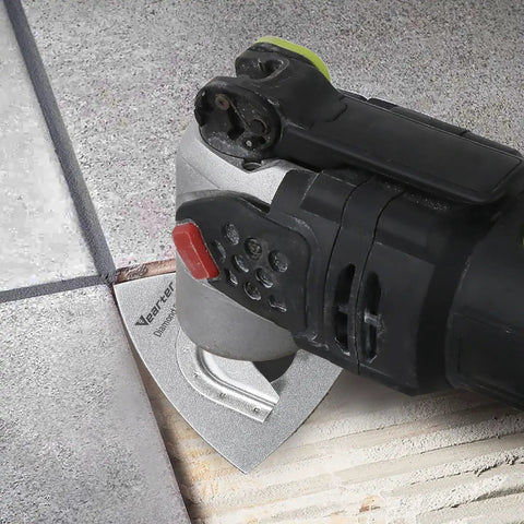 Oscillating tool using a diamond flush cut blade for tile repair, part of Six Piece Diamond Oscillating Saw Blade Set For Grout Removal