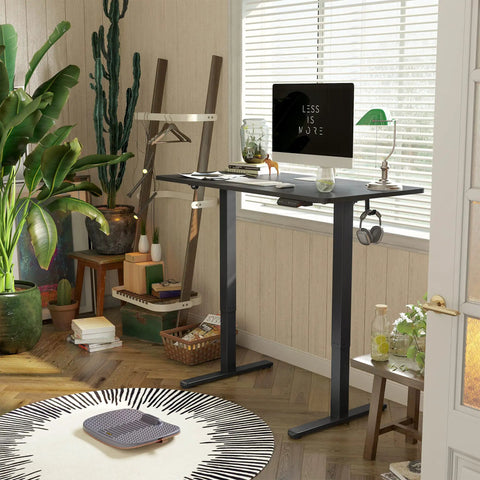 Slick Smooth Electric Sit Stand Desk 48 By 24 Inch Heavy Duty Adjustable Height Workstation in matte black with decor.