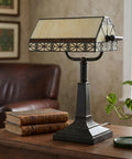 Tiffany Style Bankers Lamp With Stained Glass Shade For A Dope Desk Setup on a wooden desk next to books in cozy home office.