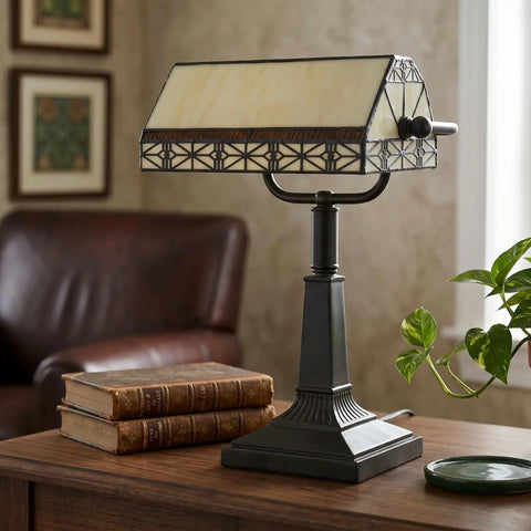 Tiffany Style Bankers Lamp With Stained Glass Shade For A Dope Desk Setup on a wooden desk next to books in cozy home office.