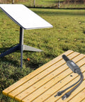 Power Over Ethernet Splitter For Mini Systems Keeps Your Setup Clean With One Cable Delivering Power And Data IP68 Rated 10 100 1000 Mbps Network Up To 100 Meters Ideal For Compact Home And Office Installations. Outdoor PoE splitter cable on bench with Starlink dish