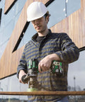 Man using Kickass 36V Brushless Cordless Drill Delivering 155 Nm Torque With Reactive Force Control Tech on wood outdoors.