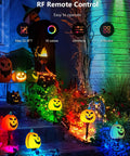 12W RGBW Color Changing Landscape Lights Low Voltage LED Pathway Spotlights Outdoor Waterproof Garden Lighting Kit 4 Pack With Remote Control illuminating a garden with Halloween decorations.