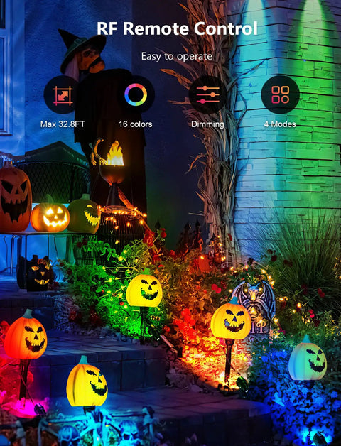 12W RGBW Color Changing Landscape Lights Low Voltage LED Pathway Spotlights Outdoor Waterproof Garden Lighting Kit 4 Pack With Remote Control illuminating a garden with Halloween decorations.