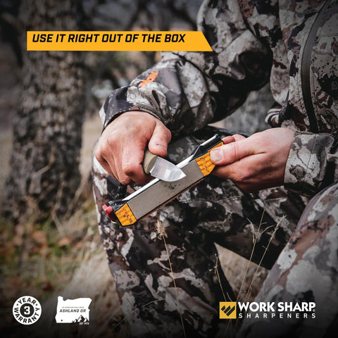 Person using Roam Ready Guided Field Sharpener With Diamond Guides And Adjustable Wrench in outdoor setting, sharpening a knife.