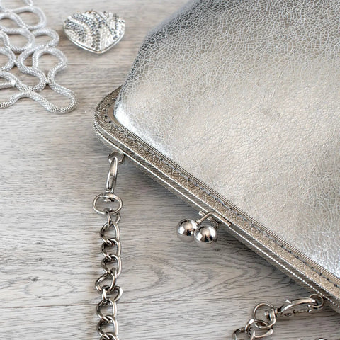Close-up of purse with 12 Pack Metal Purse Frames With Vintage Arch Kiss Lock Clasp Embossed Silver For Purse Making Handbags