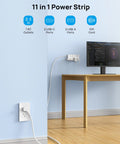 Game Changer Surge Protector Power Strip With 10 Foot Flat Plug Extension Cord on wall, powering a computer setup.