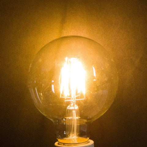 LED Edison Vintage Vanity Globe Bulbs G25 4W Dimmable With 40W Equivalent, warm glow, E26 base illuminated bulb close-up view