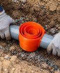 Rugged No Heat Pipe Connector For Electrical Conduit Systems Slip Socket Design shown installed on gray conduit pipe in trench.