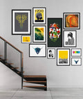 Indoor space with a gallery wall of colorful framed artworks above a modern staircase.