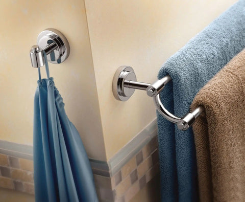 Iso 24 Inch Double Towel Bar In Chrome installed in a bathroom holding blue and brown towels, corner view.