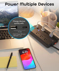 No Fuss Smart Power Strip With Individual Outlet Control, Rock Solid Surge Protection, Dual Fast Charging Usb A And C Ports, Straight Ahead Cable Management For Home Or Gaming Setup Black on desk with laptop and phone.