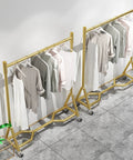 Heavy Duty Industrial Clothes Rack With Wheels Iron Single Pole Display Stand For Bedroom And Laundry shown with garments