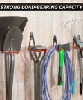 20 Pack Heavy Duty Wall Mount Hooks With Anti Slip Coating For Hanging Bikes Ladders Power Tools And Garden Gear In Garage Or Shed Space Saving Utility Hangers For Tools And Equipment holding garden tools on a wooden wall.