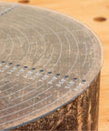 Clear acrylic 10-inch round center finder compass for drawing circles with white graduations on a lathe-work surface.